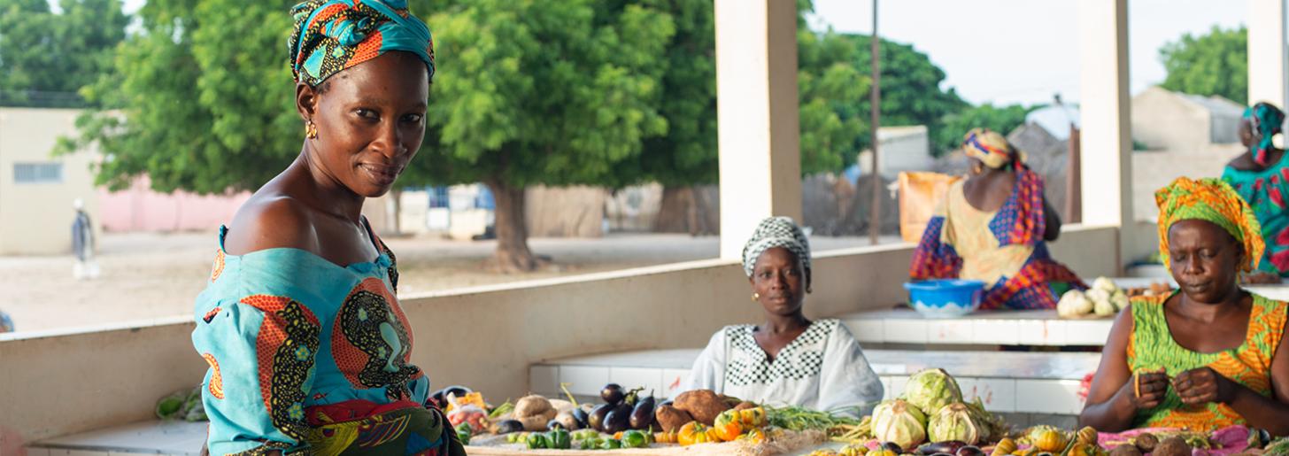 The Lekela project is helping to empower women in Taiba N’diaye, Senegal.  (From left to right) Mme. Wade, Mme. Ndiaye, and Mme. Mame Seye Gueye are proud to sell their vegetables at the market stalls.