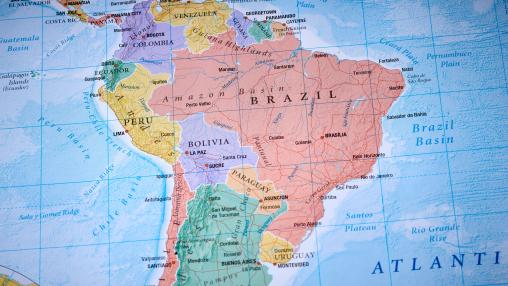A detailed printed map of South America showing country borders, major cities, and rivers. 