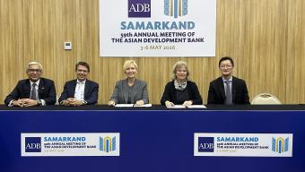 Five officials seated at a table beneath a sign for the Asian Development Bank’s 59th Annual Meeting in Samarkand, held 3–6 May 2026.