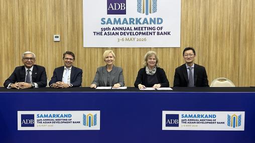 Five officials seated at a table beneath a sign for the Asian Development Bank’s 59th Annual Meeting in Samarkand, held 3–6 May 2026.