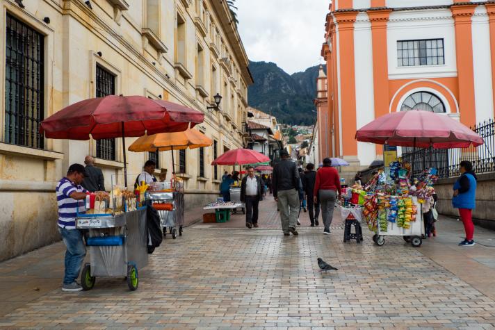 People and their small businesses on the street, Colombian fast food, Bogotá, La Candelaria district. 