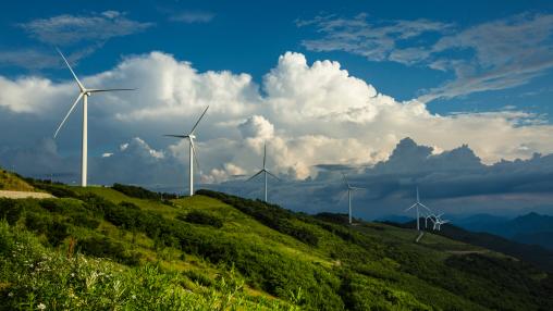 Wind power generators at Yugbaegmajigi Farm on Cheongoksan Mt with the background of cumulus in the sky
