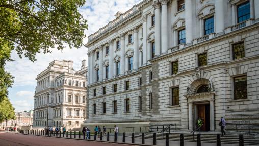 Her Majesty's Treasury Building, Government Offices in Horse Guard Road, Westminster a sunny day with white clouds and people walking