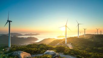 wind turbines sunset water